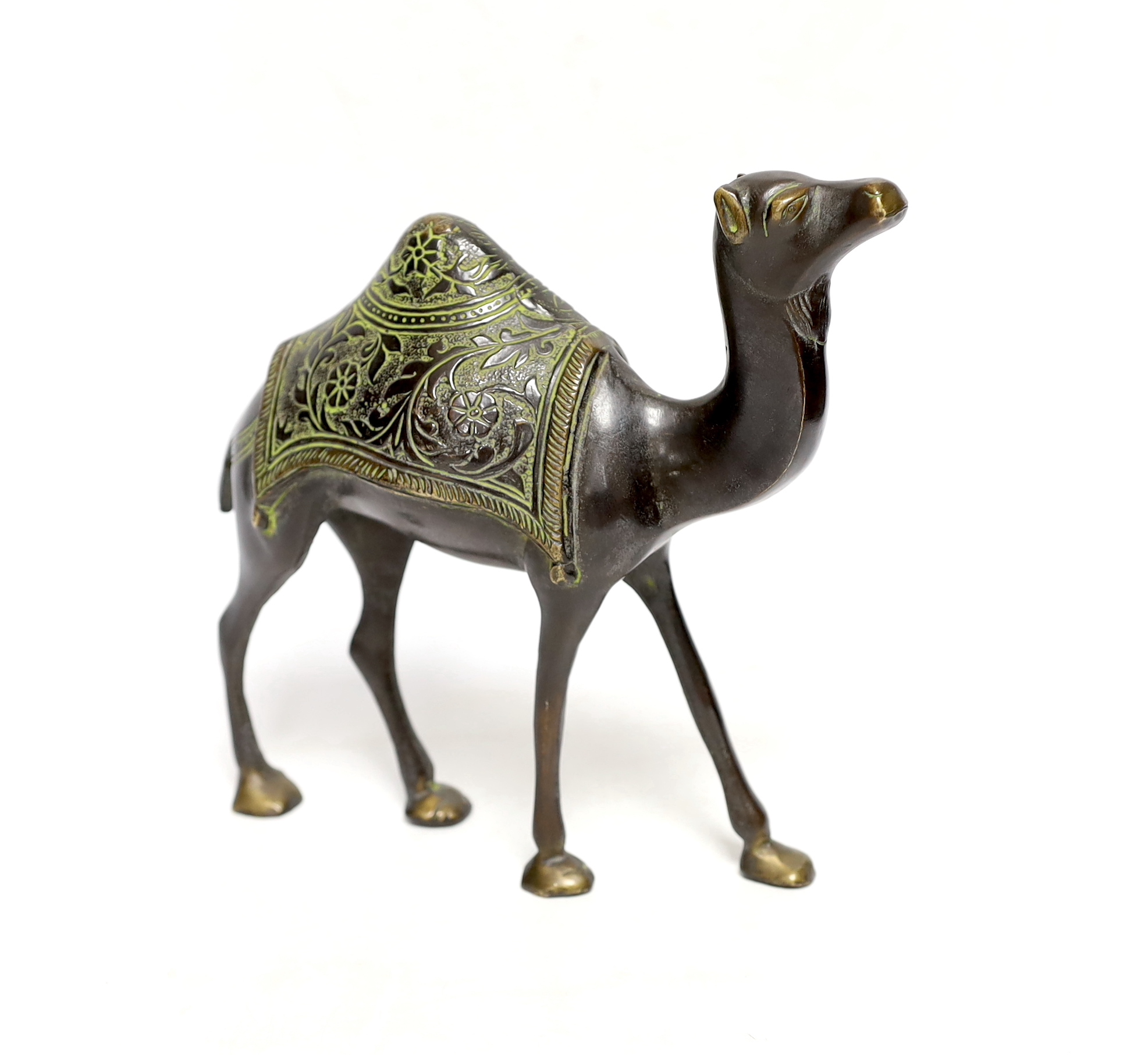 An Eastern bronze figure of a camel, 22cm wide